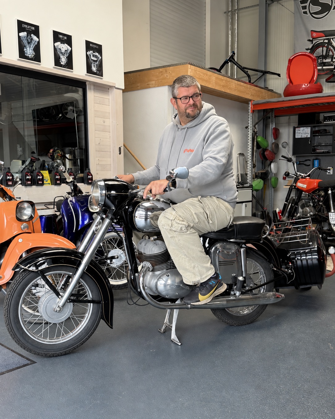 Patric in der Werkstatt auf einem Motorrad